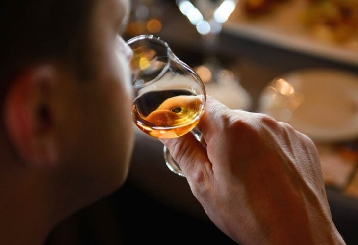 A person sampling Scotch whiskey